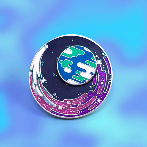 Circular Limited Edition Pin with space-themed design on a gradient blue and purple background